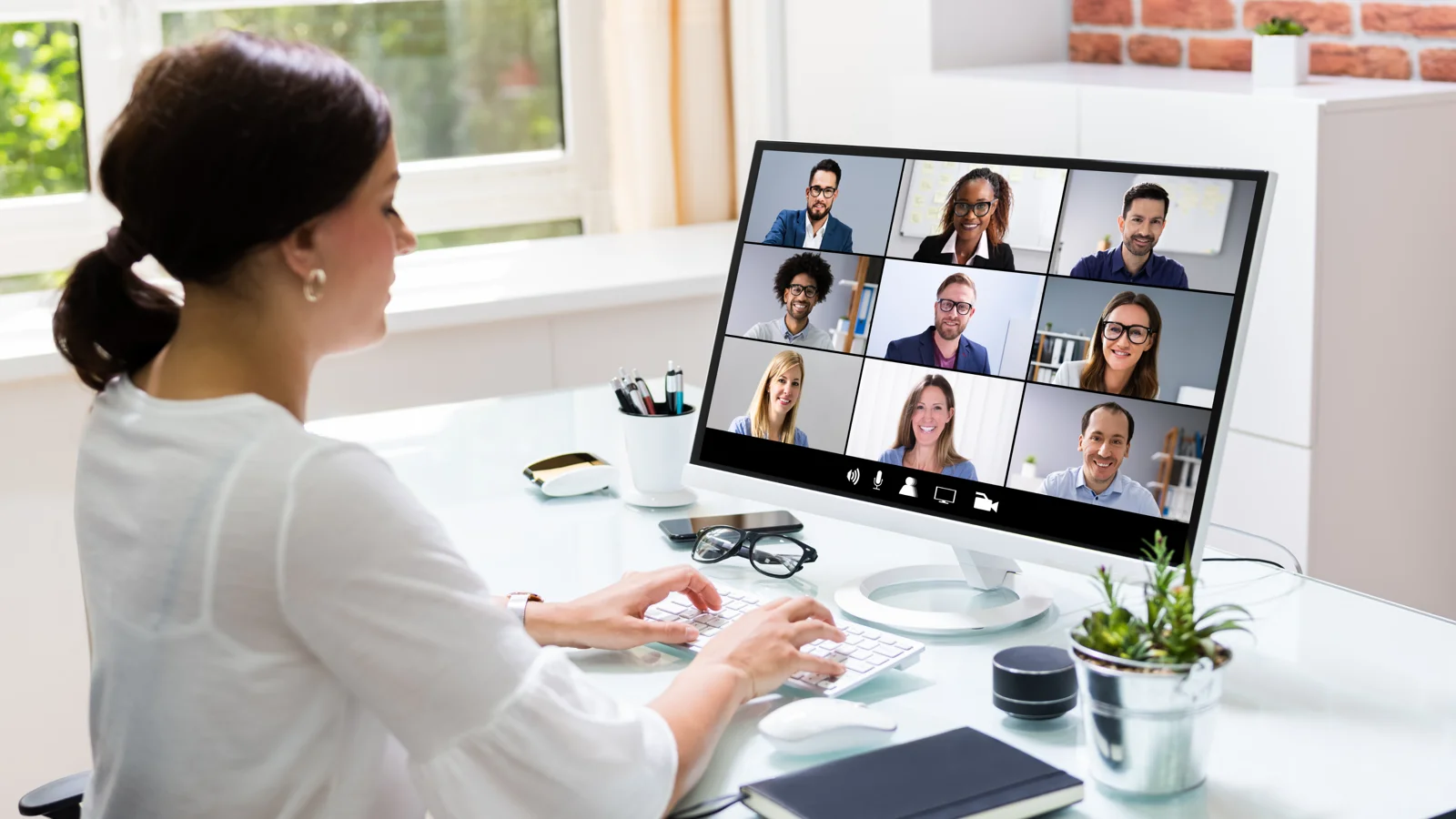 Business owner meeting with a remote team over a video call
