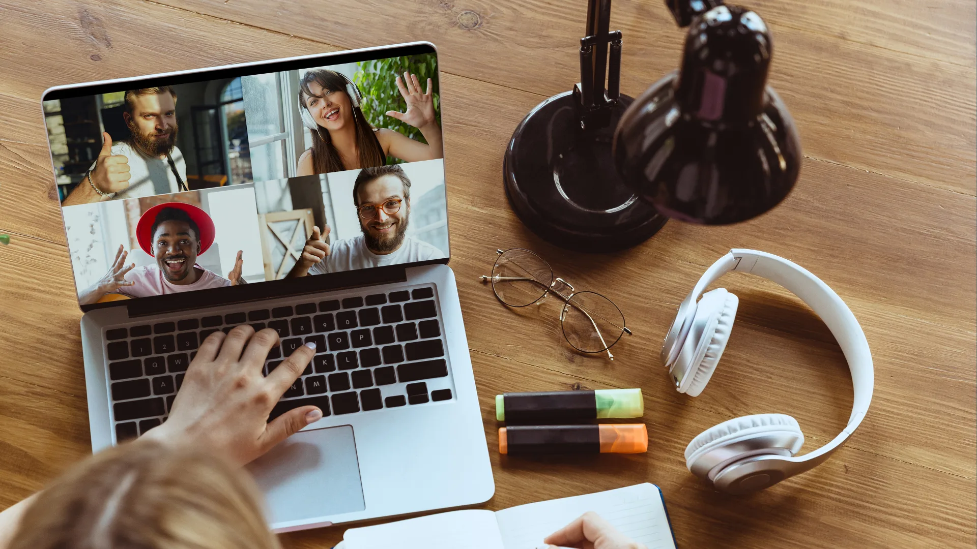 Remote team members collaborating in a video meeting on a laptop